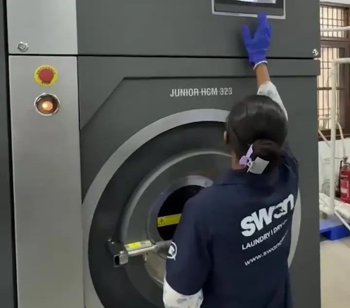 Operator at a dry-cleaning machine