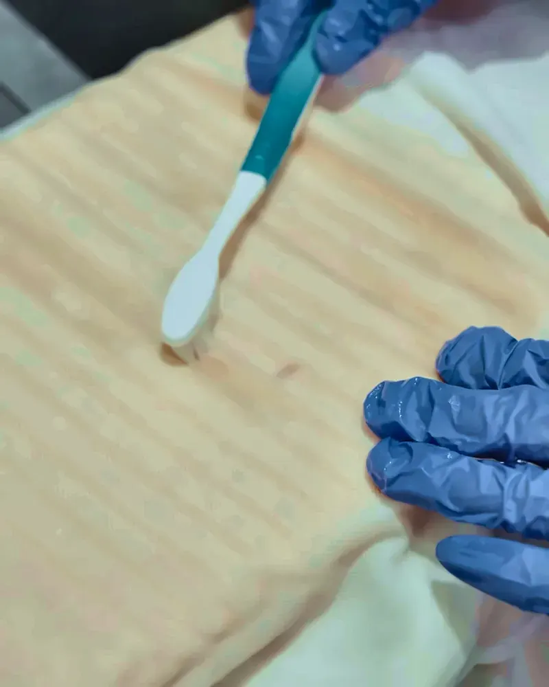 Hand stain treatment with a brush