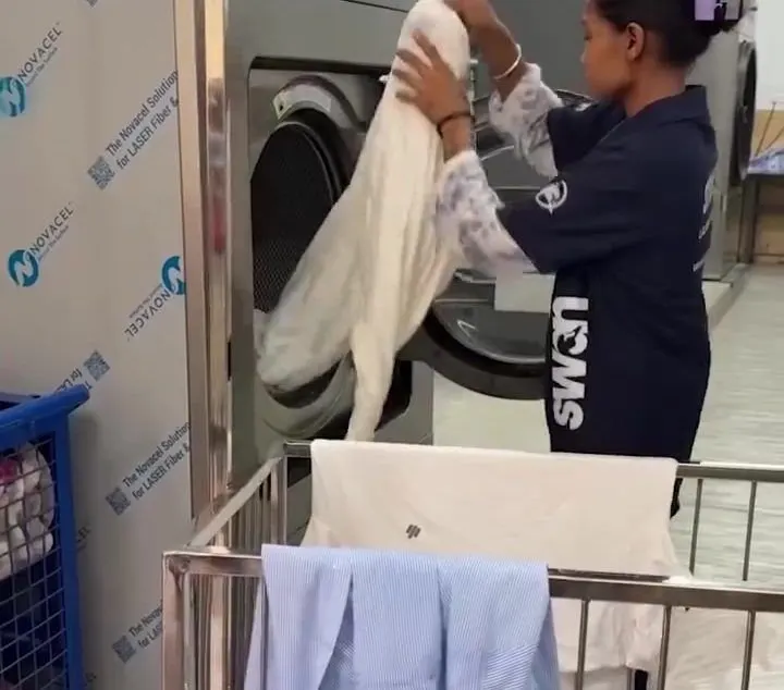 Operator unloading a washer